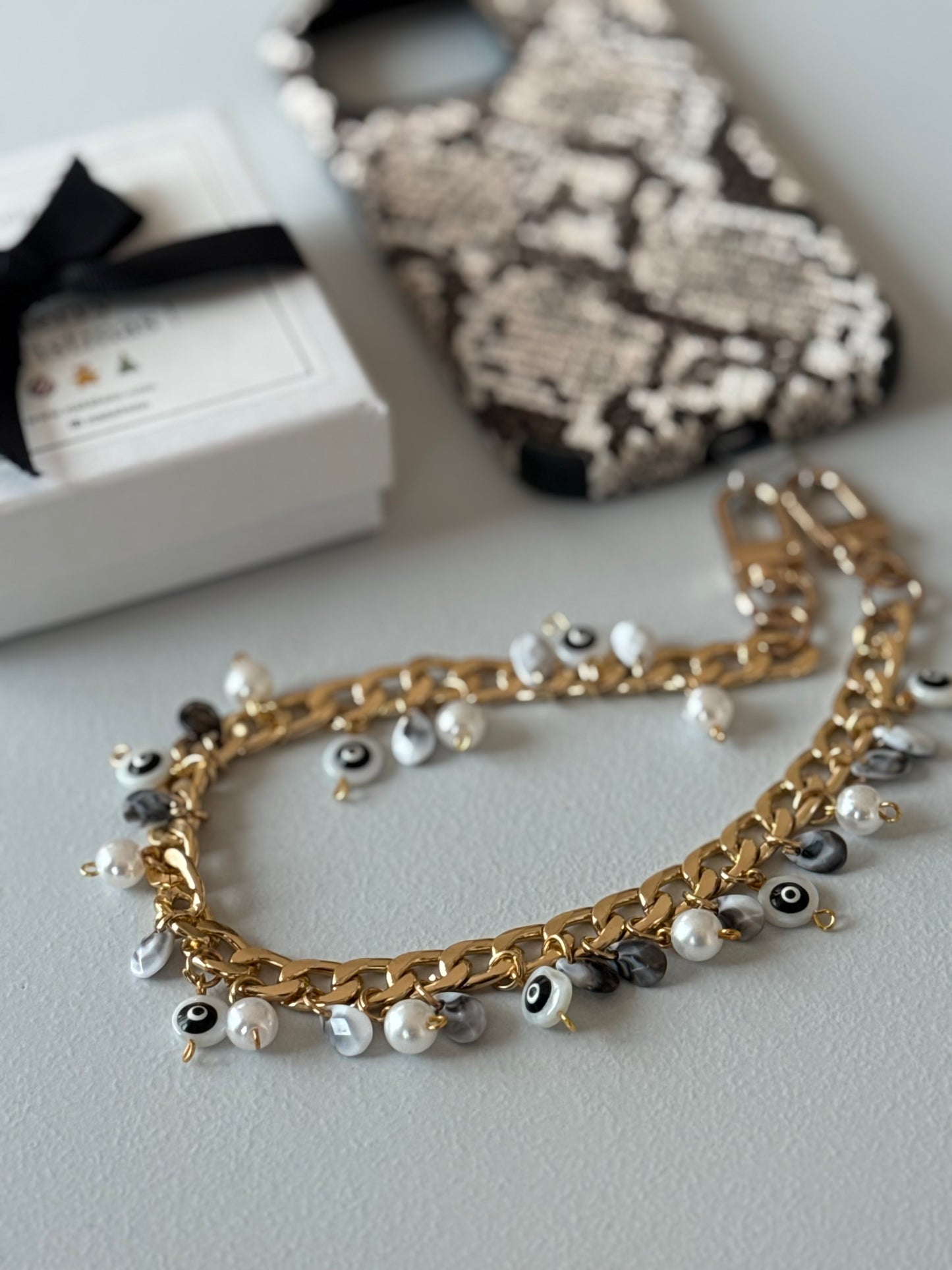 Black and Gold evil eye bauble wristlet